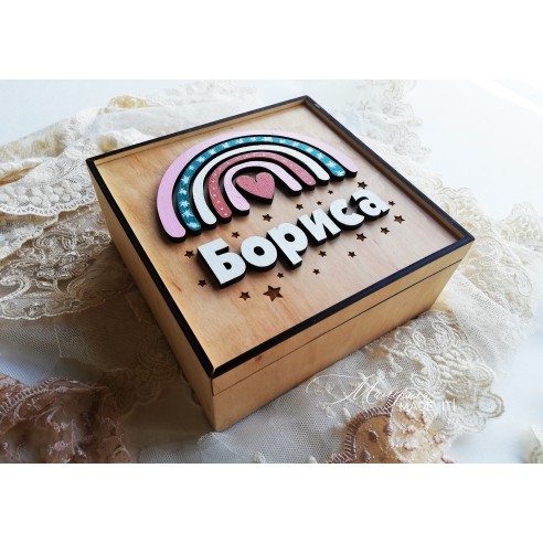 A  wooden box with a rainbow for a girl