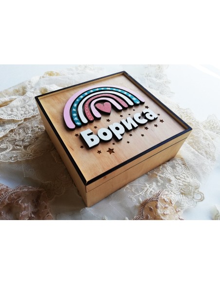 A  wooden box with a rainbow for a girl