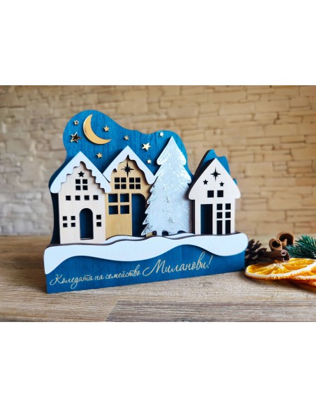 Wooden decoration with Christmas houses and gold stars