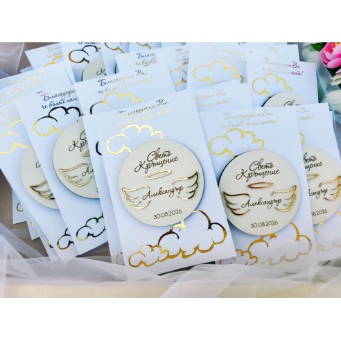 Close-up of a christening favor with angel wings